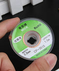 Hand holding a spool of 4Pcs 3.5mm Desoldering Braid Solder Removal Wick Wire Kit 1.5m Long for PCB cleaning and repair.