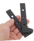 Hand holding two black metal pieces from Two Pack Heavy Duty Pivot Hinge Hidden Door Hardware For Secret Doors Easy Install Kit Built To Last Ideal For Cabinets And Home Use With Universal Compatibility And Sturdy Construction.