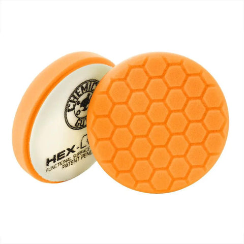 Orange pad from Hex-Logic Buffing Pad Kit 8-Piece 5.5 Inch Set for polishing cars, showing hex grooves for smooth finishes.