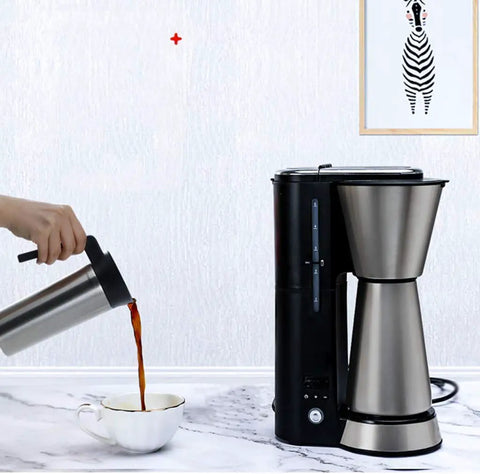 Fully Automatic Bean To Cup Coffee Maker With Integrated Milk Steam Wand Knocks Out Fresh Espresso and Frothy Lattes In Seconds with stainless steel thermal carafe pouring coffee.