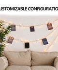 Decorative setup featuring string lights and photos hung using clips above a couch in a cozy living room.