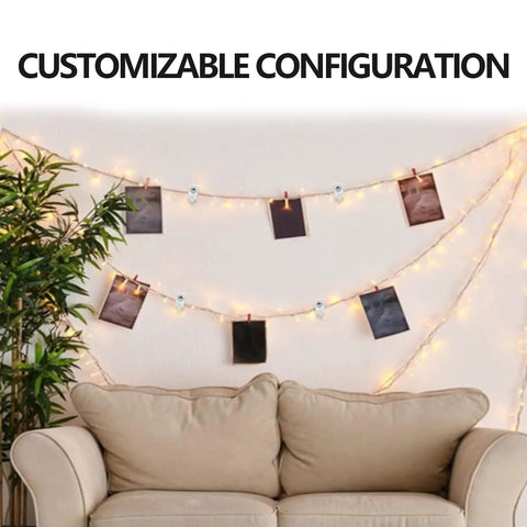 Decorative setup featuring string lights and photos hung using clips above a couch in a cozy living room.