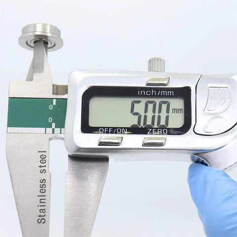 Measuring Premium 10 Pack Stainless Steel SF605ZZ Flanged Deep Groove Ball Bearings 5x14x5mm with digital caliper.