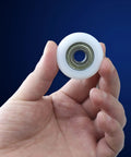 Slick Rolling 10x40x10mm Bearing Pulley With 6000ZZ Spherical Roller Nylon And Rubber Wheels Heavy Duty 4 Pack in hand showing detail.