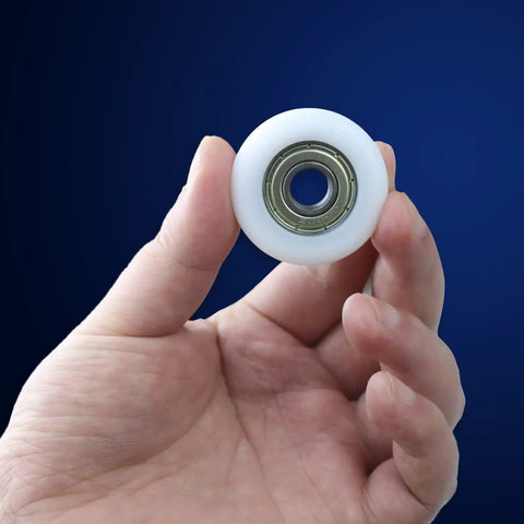 Slick Rolling 10x40x10mm Bearing Pulley With 6000ZZ Spherical Roller Nylon And Rubber Wheels Heavy Duty 4 Pack in hand showing detail.