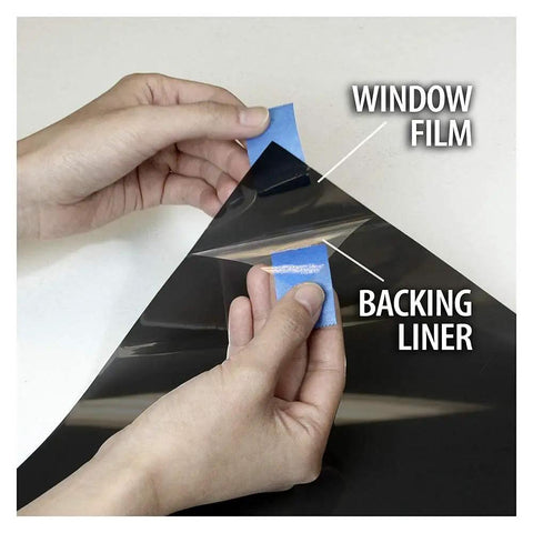 Hands peeling NA05 Window Film For Daytime Privacy And Sun Control Extra Dark Natural Black 5 Very Dark 24 Inch By 14 Feet