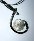 Close-up of 12/0 circle hook and braided wire from Beefy 3ft 480Lb Bite-Proof Stainless Leader for fishing, with a quarter for scale.