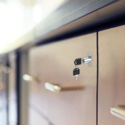 Keyed Alike Push Plunger Lock Kit With Matching Keys And Mounting Hardware installed on a cabinet drawer, showing silver cylinder and keys.