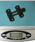 WUUWCHODC Stainless Steel Safety Snap Latch Door Bolt for Gate Hardware on a digital scale weighing 73 grams.