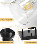 Top Shelf 4 Light Bathroom Vanity Light With Clear Glass Sleeves matte black base and E26 socket detail view.
