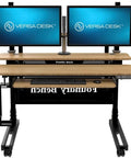 Smooth Bamboo Electric Standing Desk Riser 60 X 30 Inches with dual monitors and motorized lift for home office use.