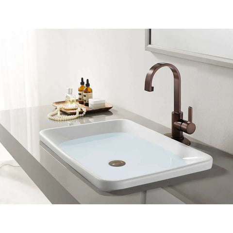 Continental Single-Handle Bathroom Faucet In Brushed Nickel With Solid Brass Construction next to a white porcelain sink on a deck mount.