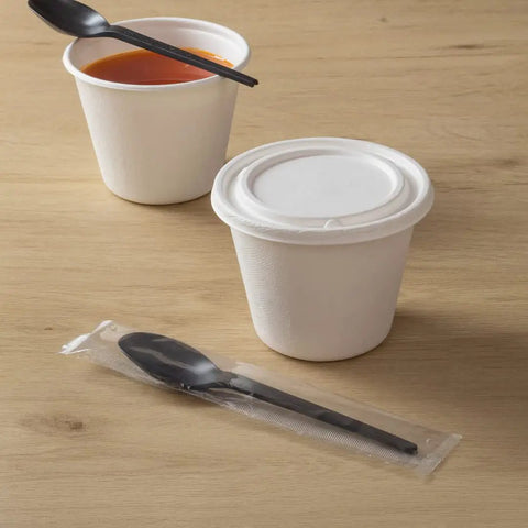 Six Point Five Inch Wrapped Compostable Spoons For Hot And Cold Food 250 Individually Wrapped Plant Based Black CPLA Disposable Utensils BPI Certified Eco Friendly Cutlery For Restaurants And Events, wrapped black spoon beside soup cups