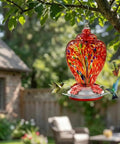 Colorful Hand Blown Glass Hummingbird Feeder For Outdoors Patio Large 32 Ounce With Ant Moat Hanging Hook Rope Cleaning Brush And Service Card Red Firework in tree
