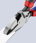 Close-up of KNIPEX lineman's pliers with red and blue grips gripping a metal edge