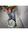 18V Cordless Mud Mixer Bare Tool for Drywall Mud Plaster and Concrete Projects in use on jobsite floor by worker
