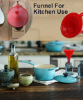 Four Piece Plastic Funnel Set With Nesting Design in Red for Kitchen, cooking pots and bottles in background. Kitchen use focus.