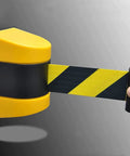Heavy Duty 10 Meter Retractable Belt Barrier Wall Mount Crowd Control Divider For Restricted Area Security Durable Nylon Ribbon visible in yellow with black stripes.
