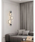 Top Shelf Modern Wall Sconce With Straight Fire Led Glow And Hella Sturdy Iron Frame Perfect For Bedroom Bedside Or Tv Backdrop Ambiance Easy Surface Mount And Super Durable Daily Lighting, sleek black design illuminating cozy living room.