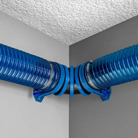 Articulating Dust Collection Fittings For 4 Inch Hose adjustable at 90 degrees in tight shop layout on a ceiling corner