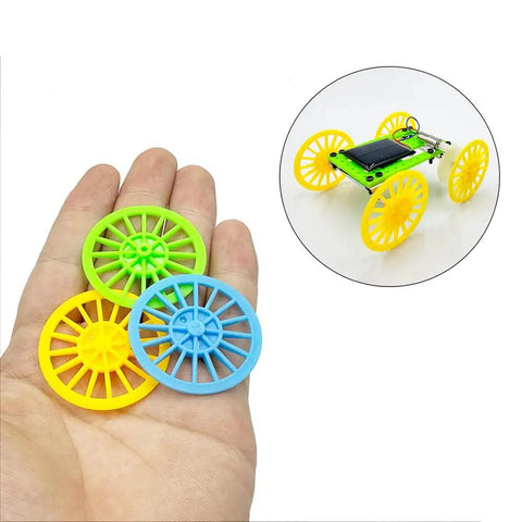 Hand holding green, blue, and yellow wheels with RC model, Dope 60 Piece Vintage Plastic Wheels Set With 30 Piece Metal Axles For RC Cars Trucks And Airplanes 37mm Wheel Diameter Fits 2mm Shafts DIY Model Toy Accessories For Custom Builds.