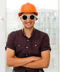 A smiling man wearing Tough As Nails Welding Safety Glasses With Anti Fog Lenses For Cutting And Grinding Workplace Protection Against Sparks And Liquid Splash Boss Level Shop Eye Gear Heavy Duty Pack and an orange hard hat.