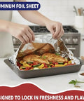 Person using Heavy Duty Aluminum Foil Roll 18 Inch By 500 Feet For Cooking And Grilling Catering And Restaurant Use Extra Thick Commercial Grade Tin Foil Resists Tears And Leaks Multipurpose Food Service Foil on roasted dish in kitchen