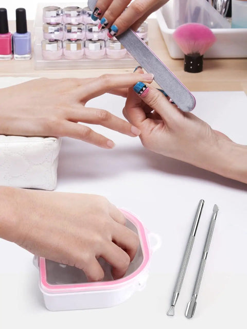 Two Pack Nail Soak Off Bowl Kit For Gel Polish Remover And Dip Powder, Includes 2 Bowls, Triangle Cuticle Peeler, Stainless Steel Cuticle Pusher, Pro Grade Nail Art Tools, Pink shown in use during a manicure session.