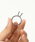 Hand holding a spring from the 8 Piece Door Handle Spring Set For Knob And Lever Latch Replacement DIY Friendly Internal Coil Repair