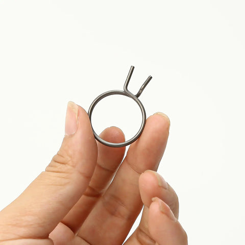 Hand holding a spring from the 8 Piece Door Handle Spring Set For Knob And Lever Latch Replacement DIY Friendly Internal Coil Repair