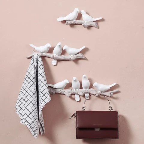 Chic Five Hook Wall Mounted Coat Rack With A Cool Blue Bird Vibe, white bird design holding coats and bags on a pink wall.
