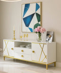 Modern sideboard with gold accents beneath geometric artwork, styled with pink flowers and gold accessories on top.