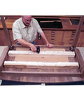 Man installing Heavy Duty Twenty Eight Inch Wood Table Extension Slides Packing Slick Rack And Pinion Action under a wooden table.