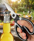 Heavy Duty Kitchen Scissors All Purpose Stainless Steel Food Shears For Meat Poultry Fish Veggies And Herbs Multipurpose Sharp Scissors With Ergonomic Grip Dishwasher Safe Black Finish Meal Prep Ready, hand holding black stainless steel kitchen scissors outdoors