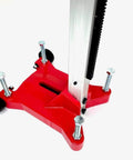 Front-left view of red rolling core-drill stand base with four adjustable feet and vertical aluminum guide rail.