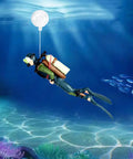 Two Pack Floating Diver Aquarium Decorations Cute Cartoon Fish Playmate That Glows In The Dark Includes Floating Balls And String For Easy Tank Setup Fun Kid Friendly Tank Accessories showing diver figure underwater with ball