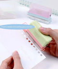 Using Grab And Go 5 Hole Paper Puncher Mini Handheld Circle Punch Tool for A4 A5 B5 paper sizes in a home office setting.