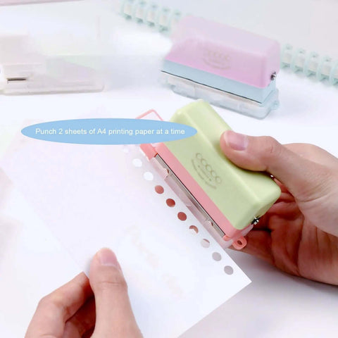Using Grab And Go 5 Hole Paper Puncher Mini Handheld Circle Punch Tool for A4 A5 B5 paper sizes in a home office setting.