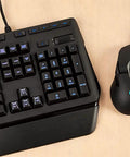 Slick Black RGB Mechanical Gaming Keyboard Featuring Prograde RomerG Switches For Lightning Fast Actuation, beside a gaming mouse.