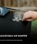 Adjusting air damper on Digital Electric Vertical BBQ Smoker With Patented Side Wood Chip Loader And Chrome Racks 710 Sq In