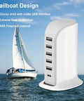 40W USB Charging Hub Workhorse with five ports and Type C 3A desktop wall charger tower next to a sailboat on the water