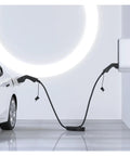 Heavy Duty Electric Vehicle Charger Cable Type 2 To Type 1 Plug 32 Amp connected to a car and wallbox in a modern setting.