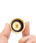 Top view of Beast RV Brass Blow Out Plug Adapter 3/4 Inch GHT Female And Male Garden Hose Quick Connect held between fingers.