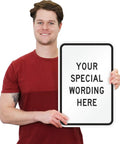 Rock Solid Custom Vertical Aluminum Sign 12 By 18 Inches held by a smiling person, featuring customizable text for outdoor use.