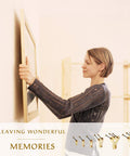 Woman using Heavy Duty 125 Piece Picture Hanging Kit With Tough Nails And Wall Anchors For Drywall And Wood Surfaces to hang a picture.