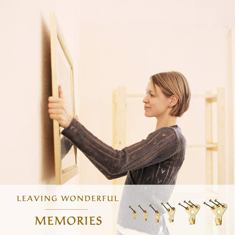 Woman using Heavy Duty 125 Piece Picture Hanging Kit With Tough Nails And Wall Anchors For Drywall And Wood Surfaces to hang a picture.