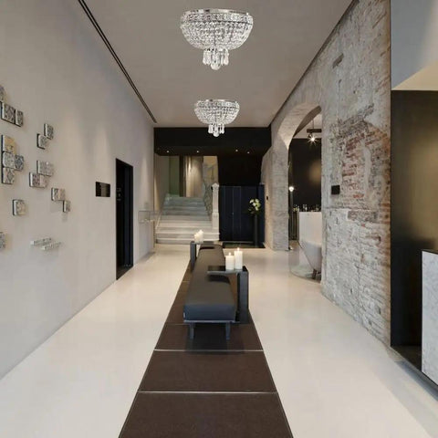 Two-Light Round Crystal Flush Mount Ceiling Light In Antique Brass Finish, 12-Inch Diameter illuminating a modern hallway.