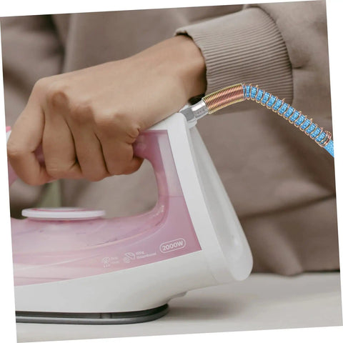Close-up of hand holding a steam iron connected to High Temperature Steam Hose for Steam Irons, heavy duty flexible tube