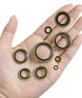 A hand holding assorted sizes of sealing washers from a 378 Piece NBR Metal Bonded Sealing Washer Kit With 12 Sizes M6 Through M30 For Automotive Self Centered Seal Gasket Repair Set, High Pressure And Heat Resistant Rubber To Metal Gaskets.
