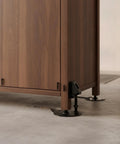 Adjustable Cabinet Feet For Uneven Floors Heavy Duty Cold Rolled Steel supporting a wooden cabinet corner on concrete